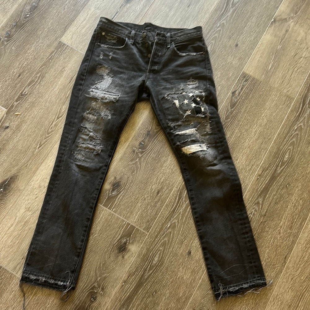 Ralph Lauren Denim and Supply distressed black jeans with star patch detail.